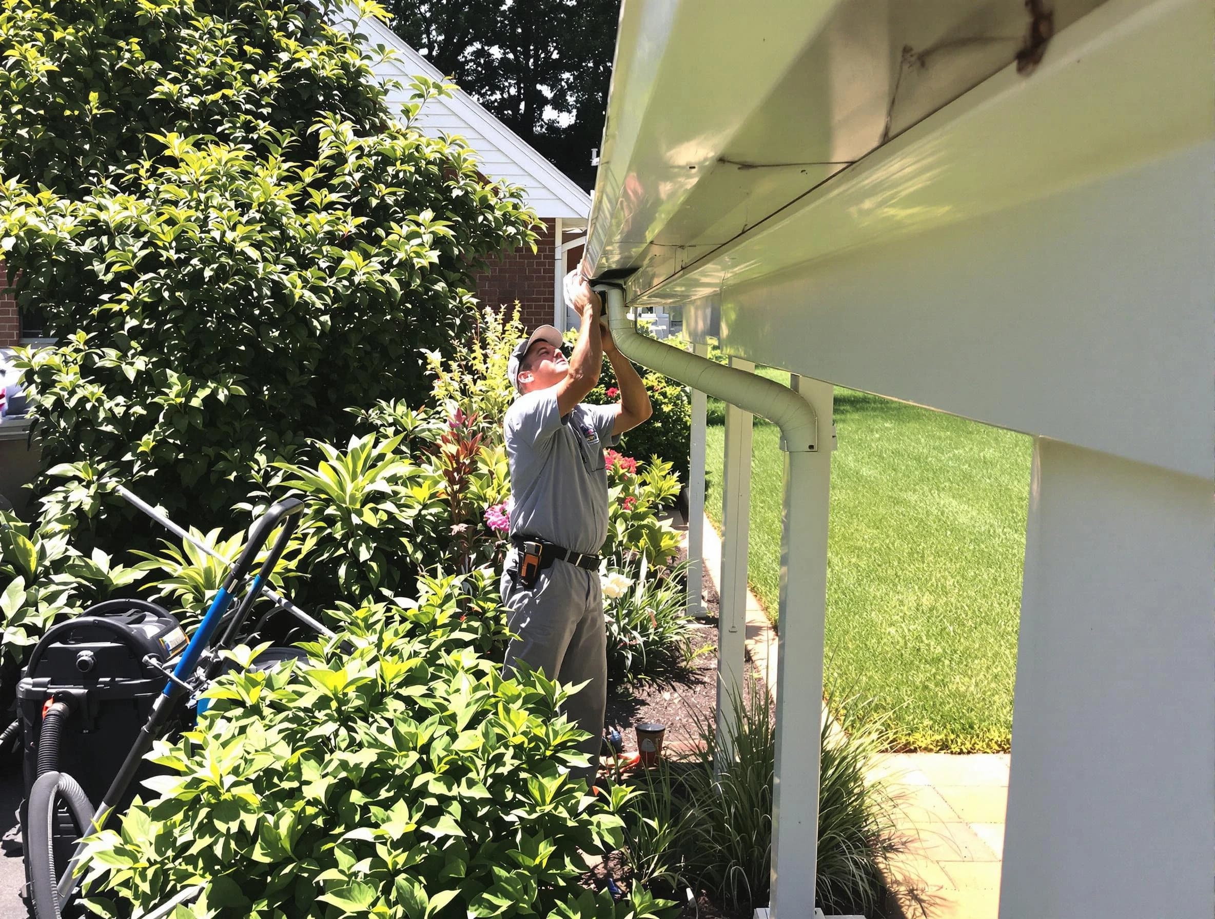 Technician flushing a blockage from a downspout in Wickliffe, OH